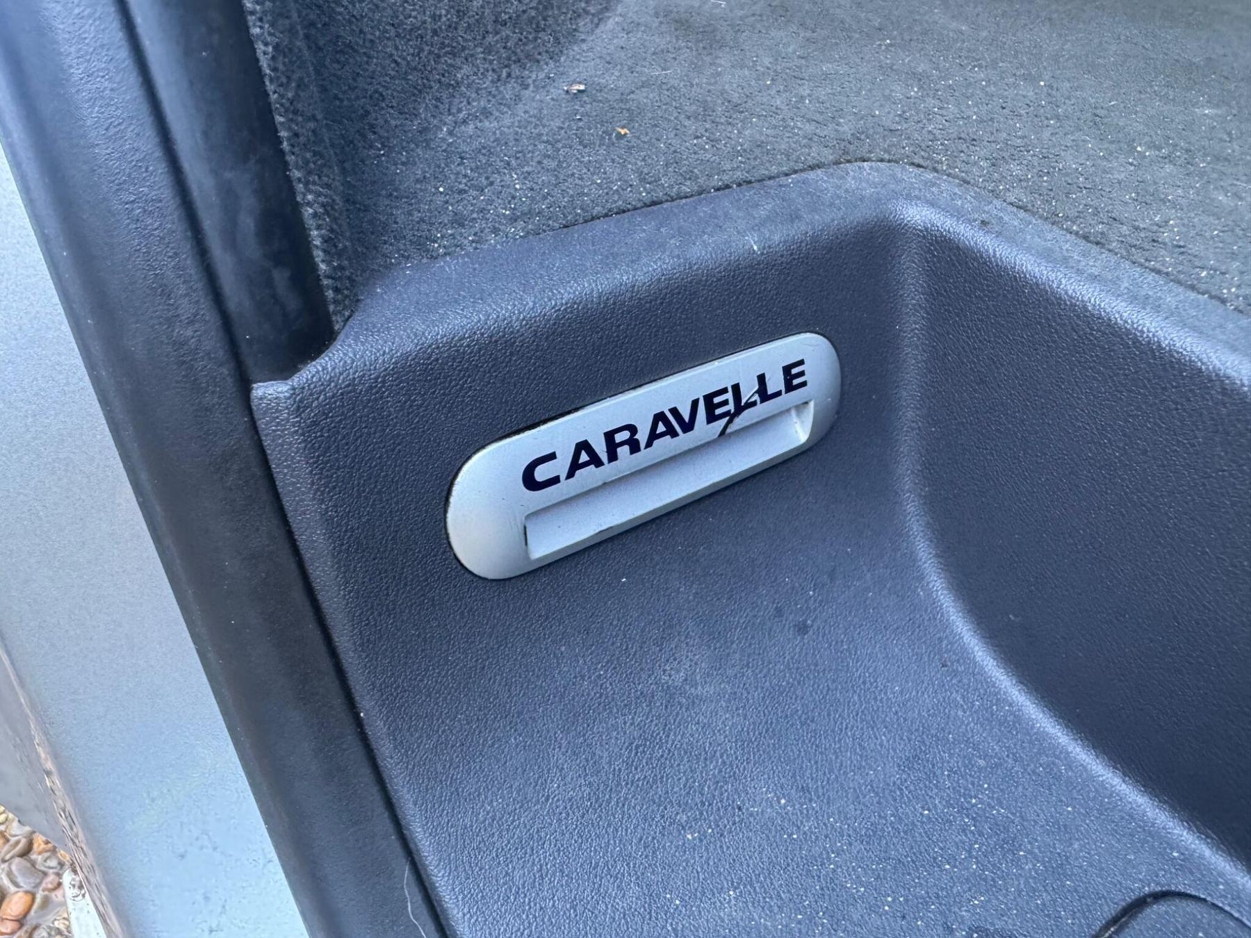 Close up of the Caravelle badge on the door step of a Volkswagen Caravelle